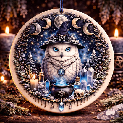 Wicca Yule ceramic ornament with a white owl in a witch hat, moon phases, cauldron, and crystals.