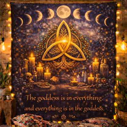 Dark blue tapestry with golden Celtic Triquetra, moon phases, candles, and a "goddess" quote.