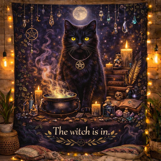 Mystical black cat witchy tapestry with glowing yellow eyes, cauldron, candles, crystals, and "The witch is in." text.