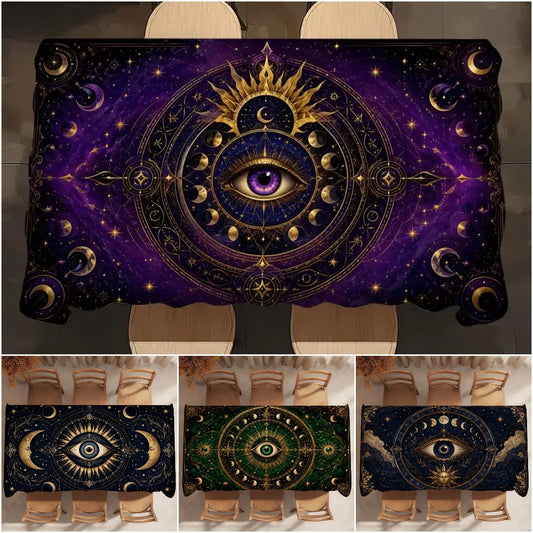 A rectangular tablecloth featuring an intricate cosmic all-seeing-eye design with gold celestial motifs on a deep purple and black starry background. The main image shows the tablecloth styled on a dining table with chairs, while three smaller thumbnails at the bottom display additional color variations of the print.