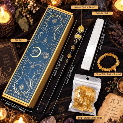 A boxed crystal set arranged on a dark cloth with candles and crystals around it. The main product is a blue and gold gift box labeled with dimensions, alongside a white citrine wand, a silver-tone selene stick, a bracelet of yellow citrine chips, and a small bag of natural citrine chips.