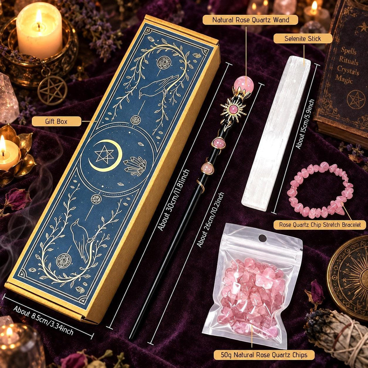 A mystical wiccan/spellbinding set displayed on a dark purple velvet cloth, featuring a dark blue and gold gift box, a rose quartz wand, a white saltire stick, a pink rose quartz chip bracelet, and a bag of natural rose quartz chips, with dimension labels overlaid.