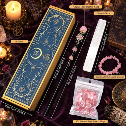 A mystical wiccan/spellbinding set displayed on a dark purple velvet cloth, featuring a dark blue and gold gift box, a rose quartz wand, a white saltire stick, a pink rose quartz chip bracelet, and a bag of natural rose quartz chips, with dimension labels overlaid.