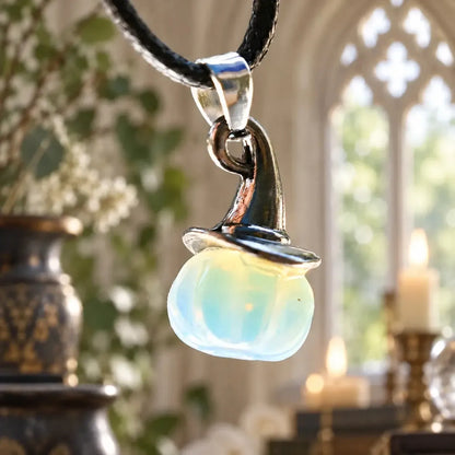 Opalescent pumpkin witch hat pendant close-up on a cord