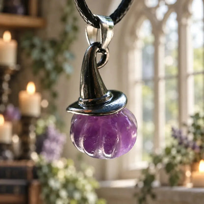 Purple pumpkin witch hat pendant close-up on a cord