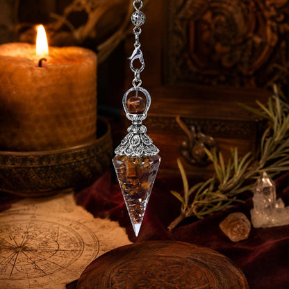 Tiger eye spirit pendulum on a warm Wiccan ritual altar