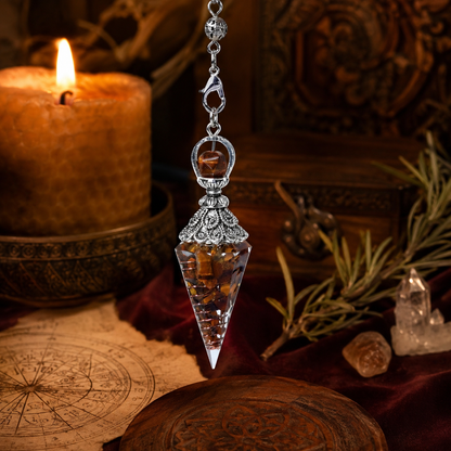 Tiger eye spirit pendulum on a warm Wiccan ritual altar
