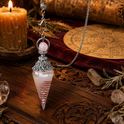 Rose quartz spirit pendulum on a warm Wiccan ritual altar