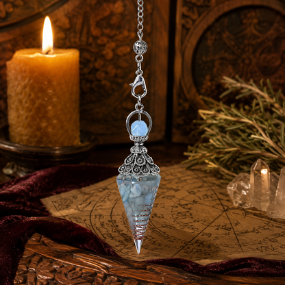 Aquamarine spirit pendulum on a warm Wiccan ritual altar