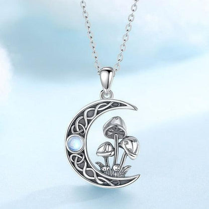 Sterling silver Celtic knot crescent moon necklace with opal and mushroom design.
