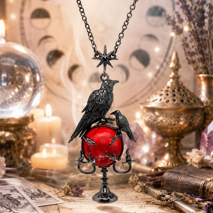Gothic-style necklace with crow and red gemstone pendant on a mystical background