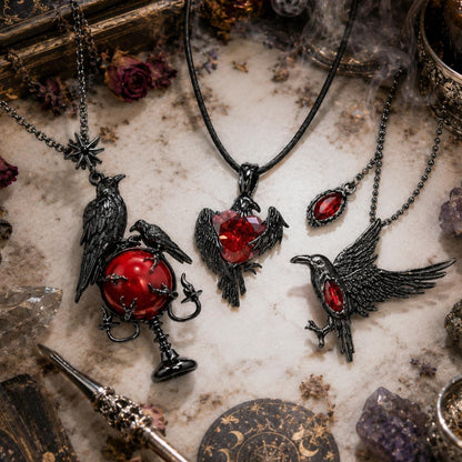 Gothic-style jewelry with ravens and red stones on a mystical background