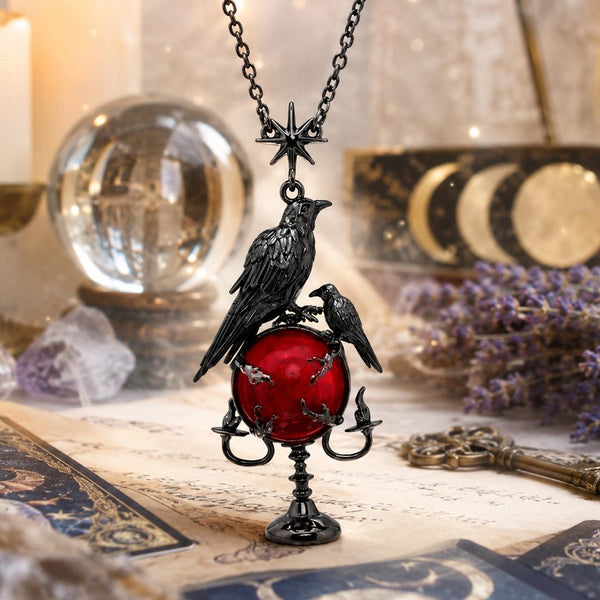 Necklace with a raven and red egg pendant on a mystical background with candles, crystals, and lavender.