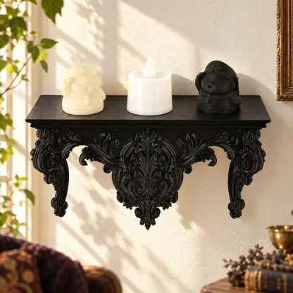 Rococo wall shelf holding small figurines and a white flameless candle