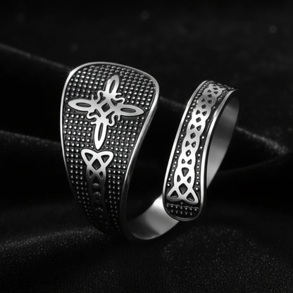 Silver Witch Knot open ring with Celtic trinity and endless knot design, close-up on black background