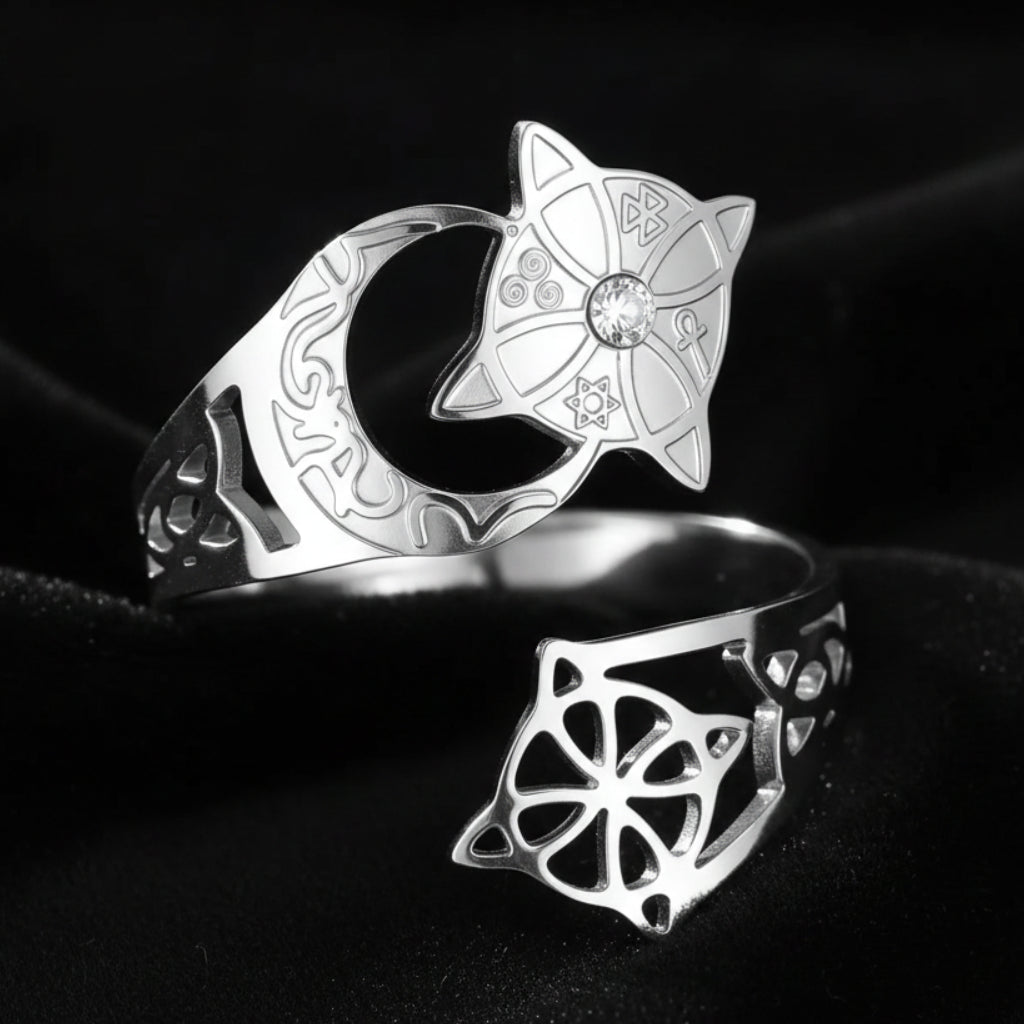 Silver Celtic knot crescent moon ring in an elevated top-down view, showing the engraved lunar band, star medallion with clear stone, and open celtic knot cutout on the adjustable open band.