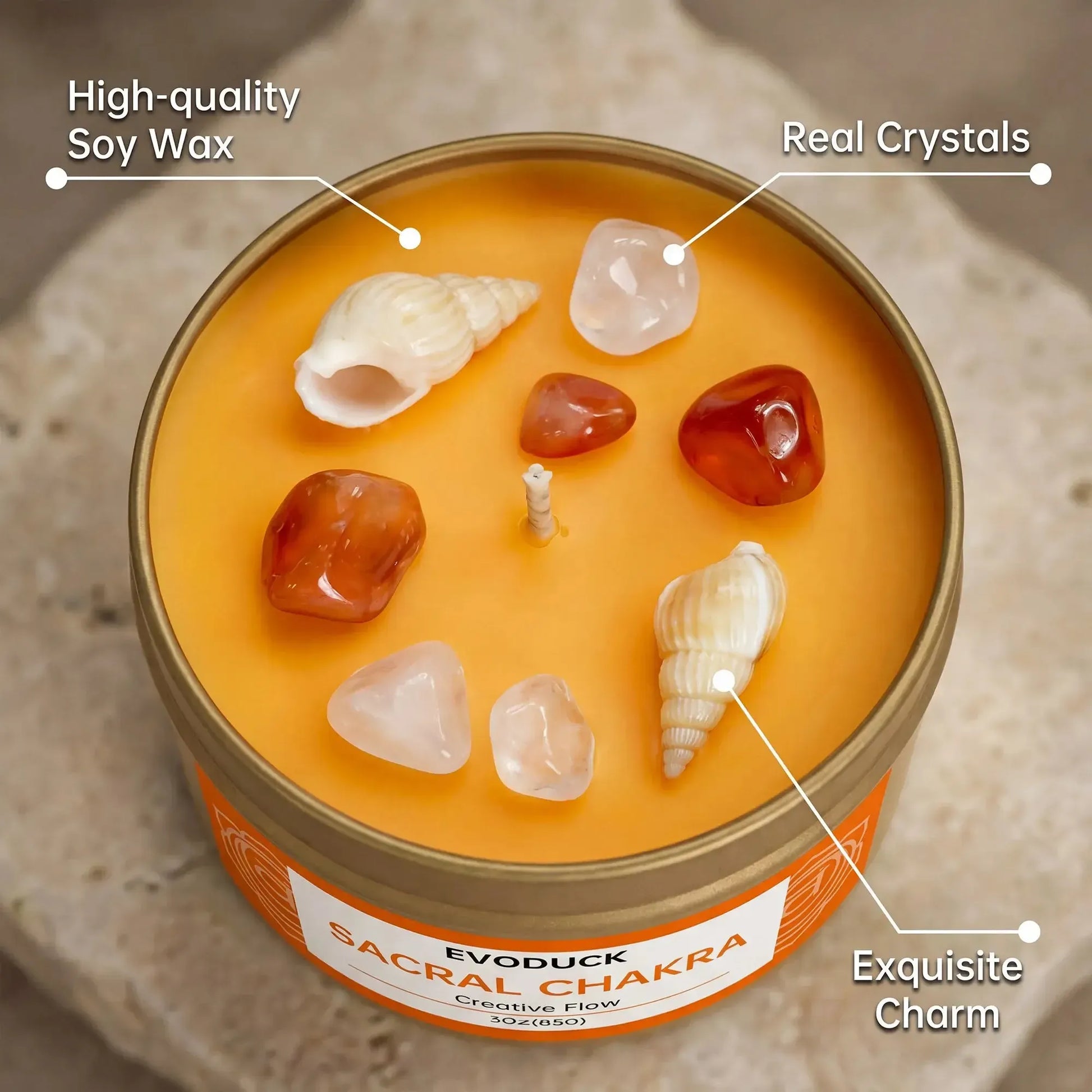 Sacral Chakra candle close-up labeled with soy wax, real crystals, and seashell charm