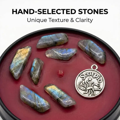 Close-up of Scorpio Candle dark red wax with labradorite crystal chunks and a Scorpio scorpion charm - Hand-Selected Stones, Unique Texture and Clarity