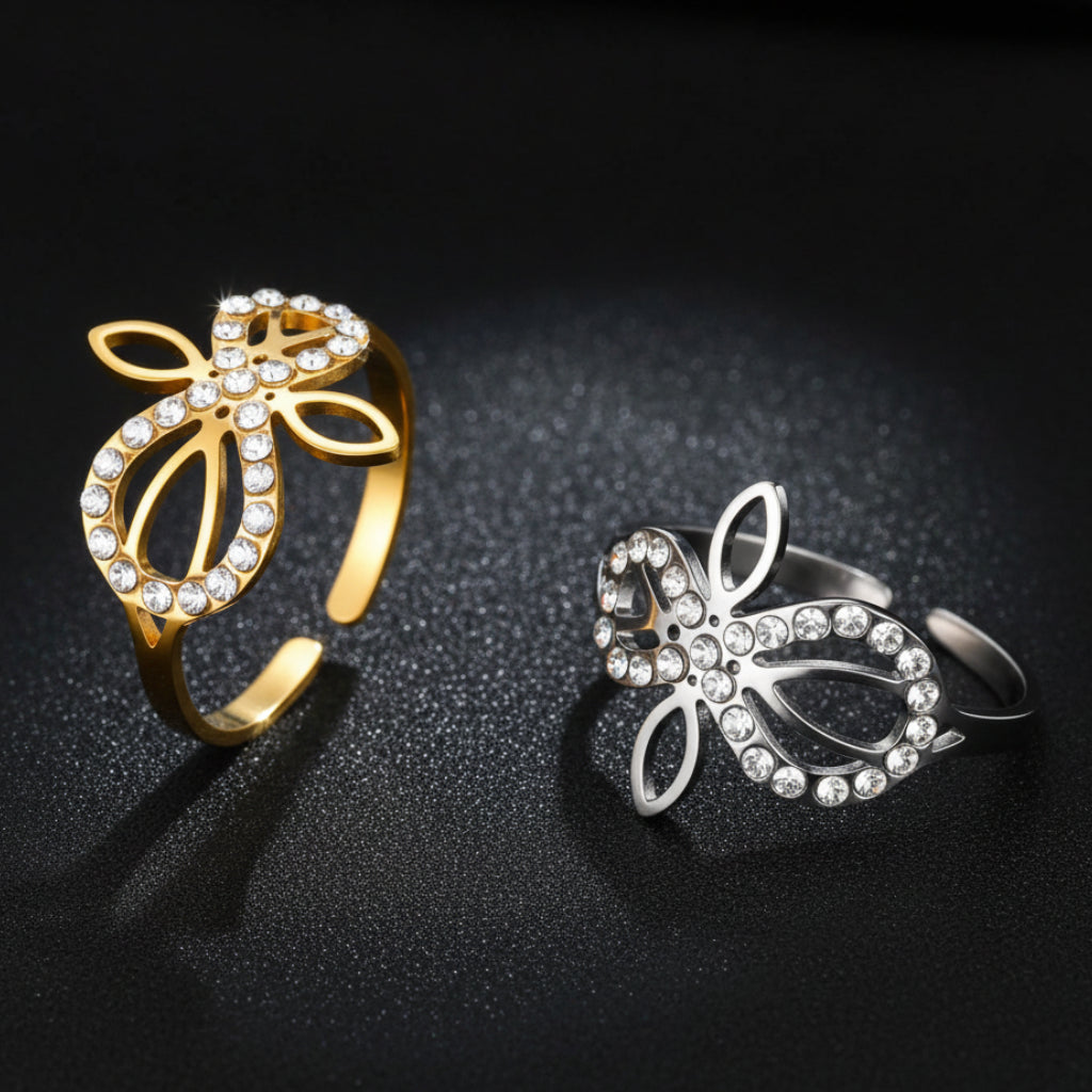 Gold and silver Infinity Celtic knot zircon rings standing side by side, showing the adjustable open-band design and sparkling stone details