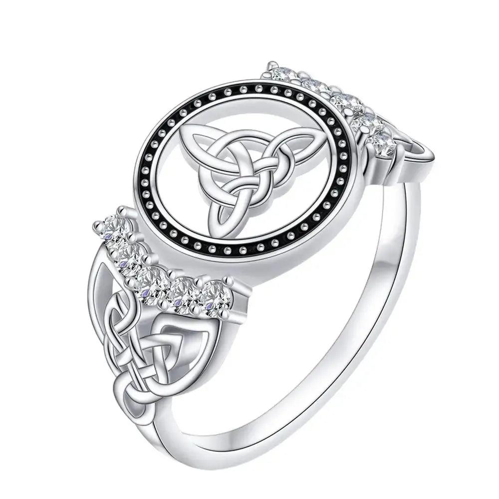 925 sterling silver Celtic knot ring with a central Triquetra symbol, surrounded by black dots and clear gemstones.