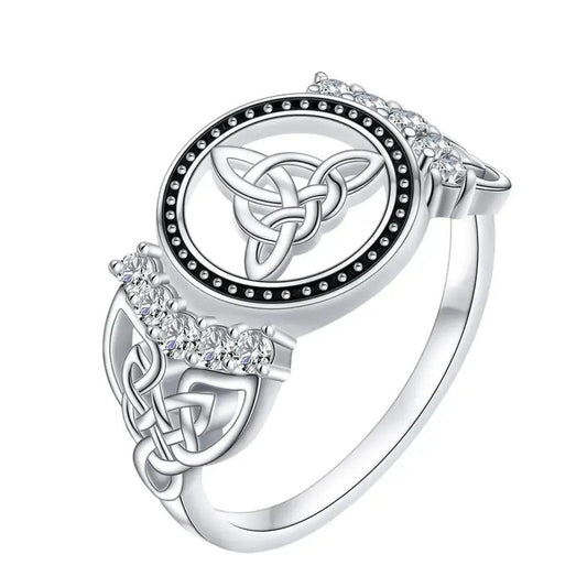 925 sterling silver Celtic knot ring with a central Triquetra symbol, surrounded by black dots and clear gemstones.