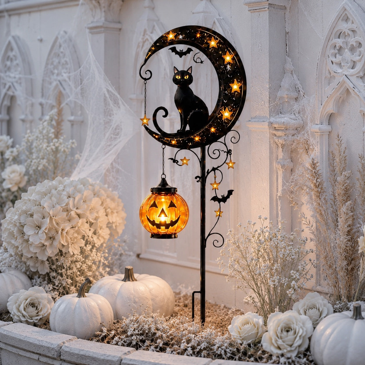 Black cat and bat solar garden stake light with white pumpkins gothic arch backdrop