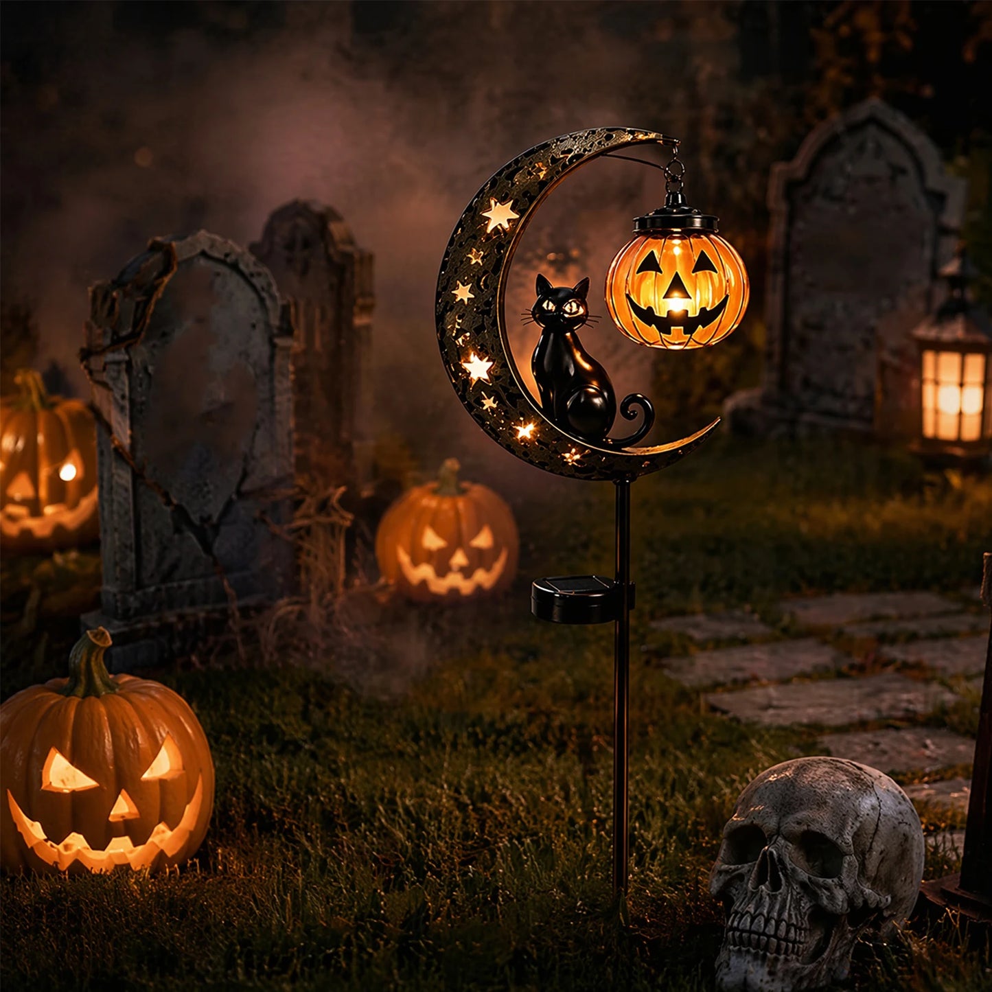 Black cat pumpkin moon solar stake light glowing in spooky graveyard with tombstones