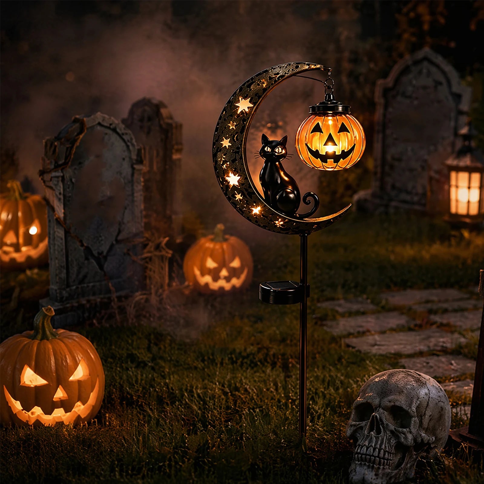 Black cat pumpkin moon solar stake light glowing in spooky graveyard with tombstones