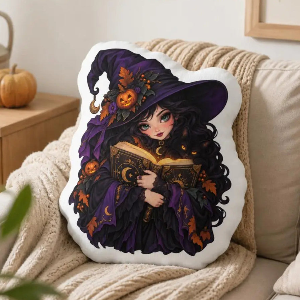 Printed pillow displayed on a sofa: decorative plush pillow featuring witch with spellbook artwork