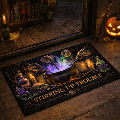 Black witchy doormat with "Stirring Up Trouble" text, a cauldron, hands, candles, and potions.