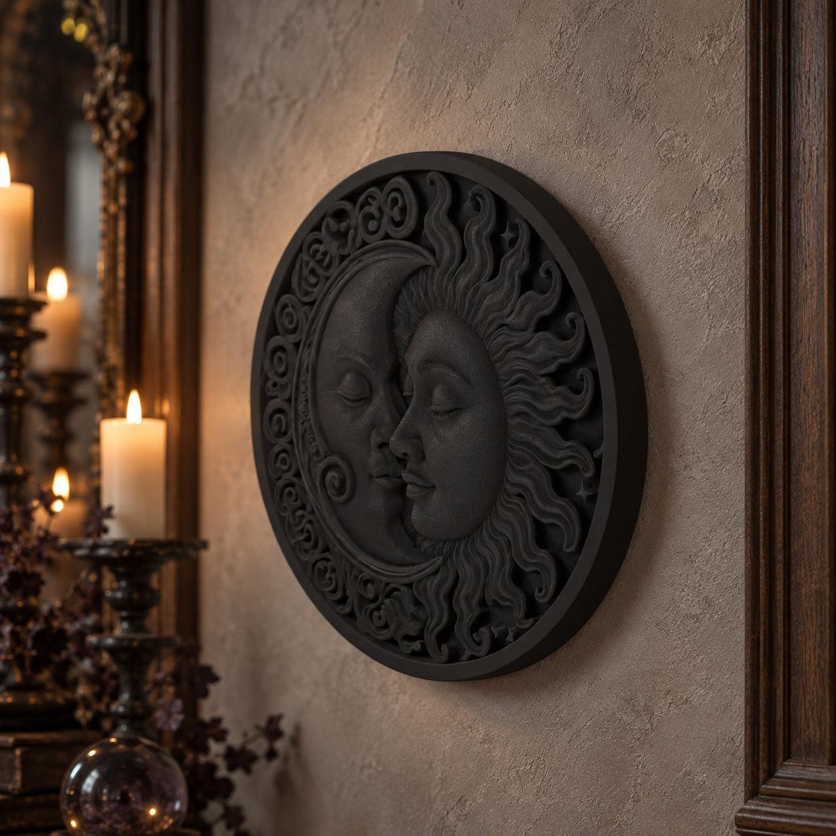 Oblique sun and moon wall plaque showing raised faces and a circular scrollwork border