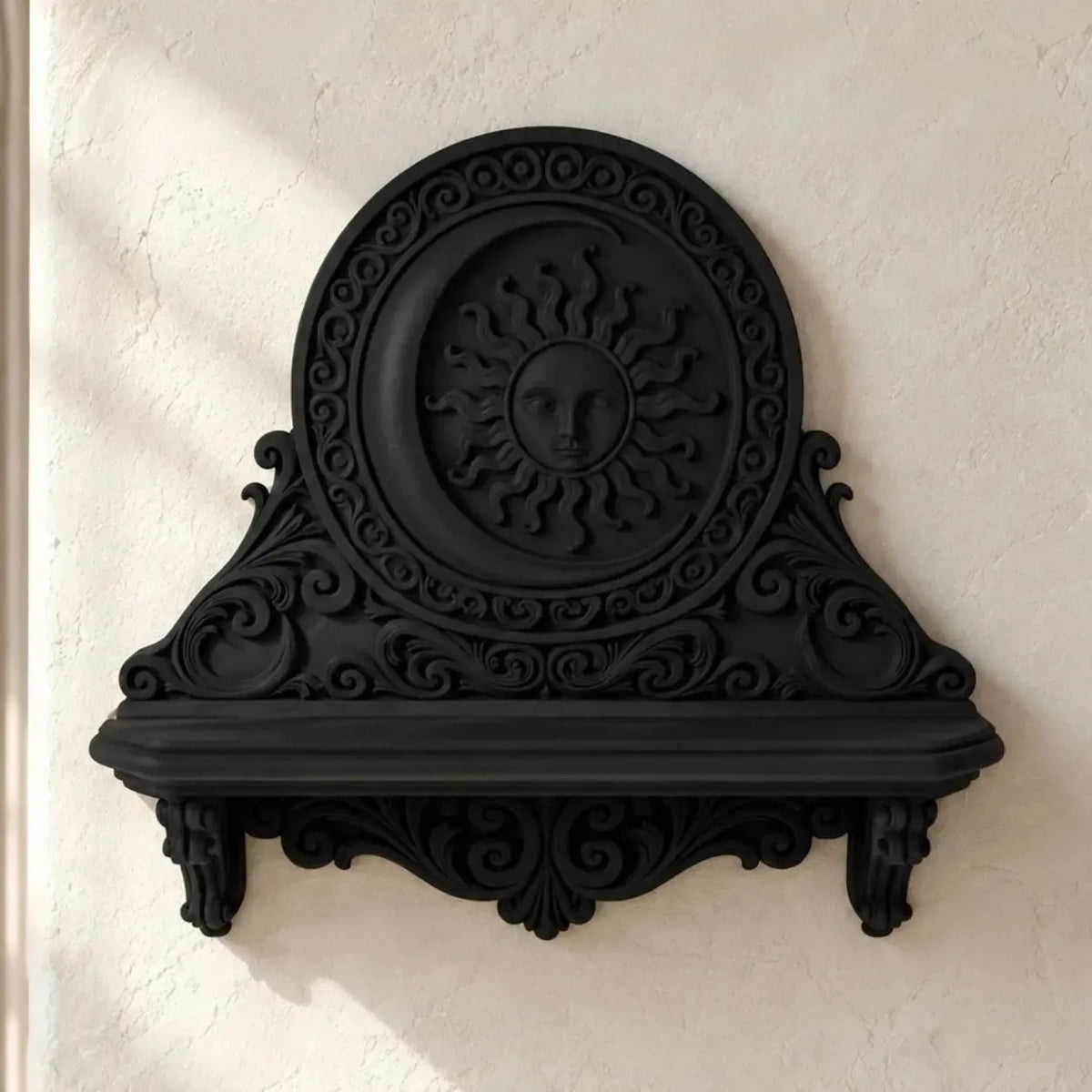 Black sun and moon wall shelf with ornate scrollwork on a bright gothic ivory wall