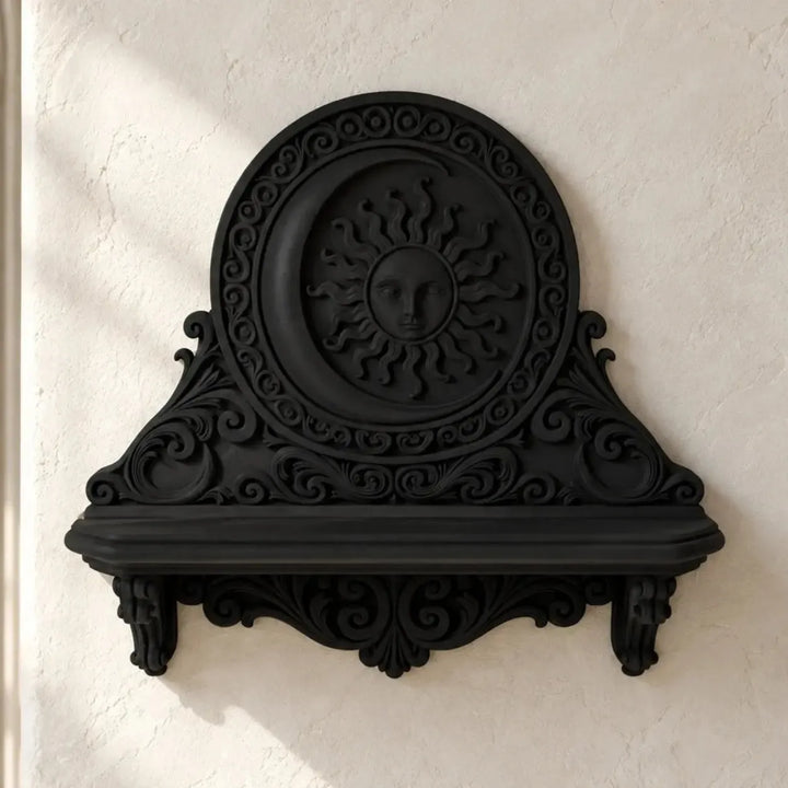 Black sun and moon wall shelf with ornate scrollwork on a bright gothic ivory wall