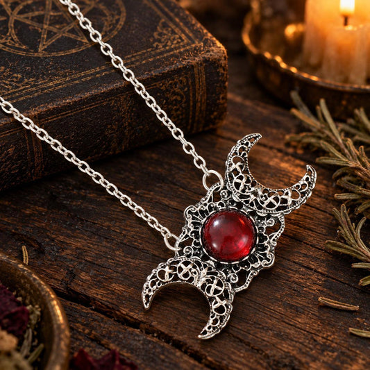 Triple Moon Goddess necklace with red center stone in dark Wiccan scene, view 5