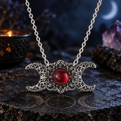 Triple Moon Goddess necklace with red center stone in dark Wiccan scene, view 6