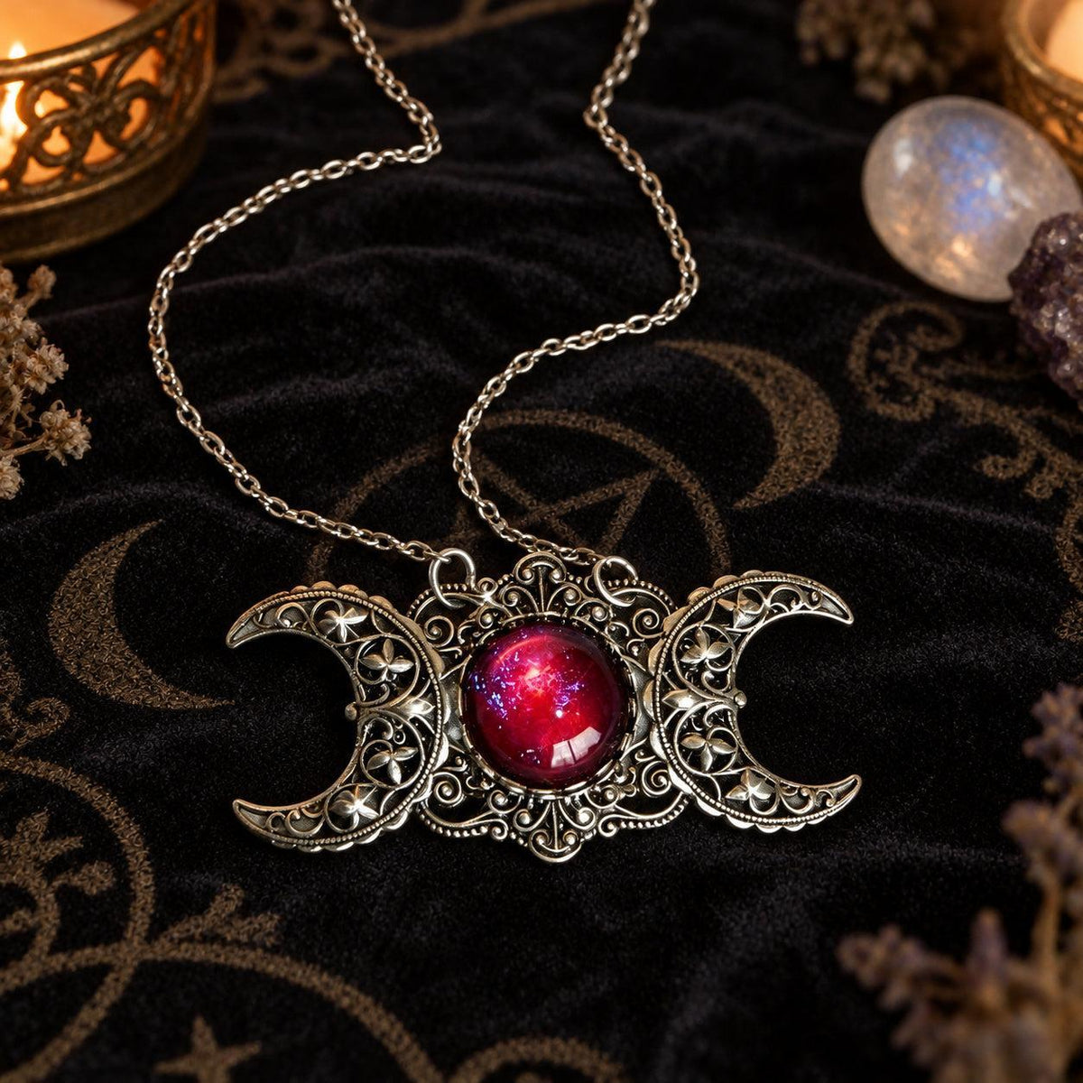 Triple Moon Goddess necklace with red center stone in dark Wiccan scene, view 1