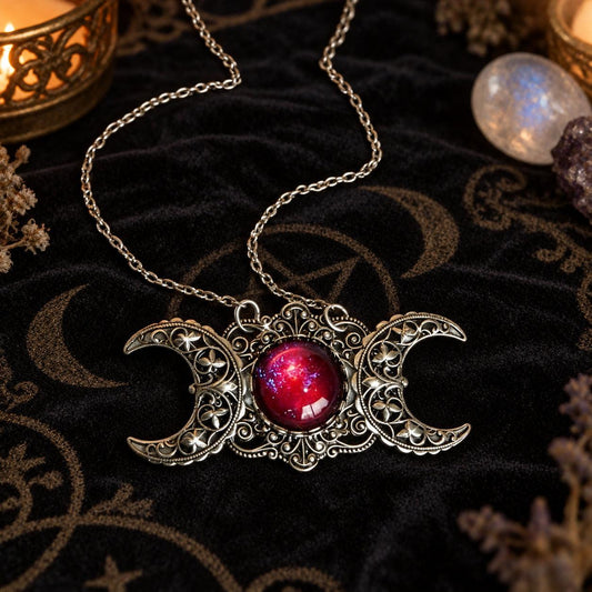 Triple Moon Goddess necklace with red center stone in dark Wiccan scene, view 1