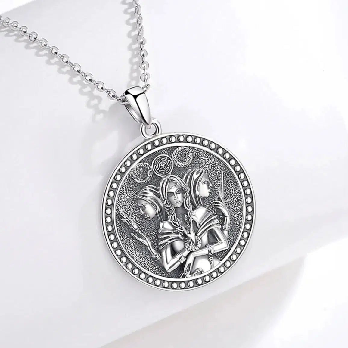 Sterling silver Triple Moon Goddess Hecate Amulet necklace with intricate Witch Knot and three goddess figures.