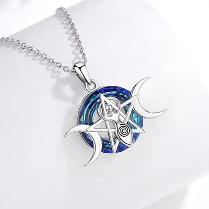 Triple Moon necklace on a pale display surface