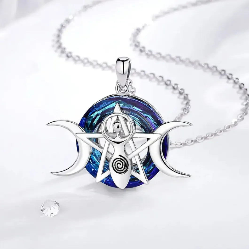 Spiral goddess necklace arranged beside white fabric