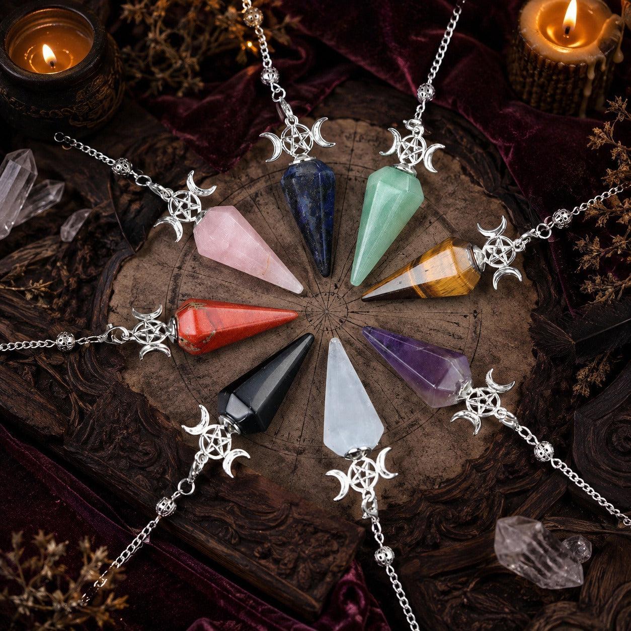 Eight Triple Moon crystal pendulums arranged on a candlelit Wiccan ritual altar