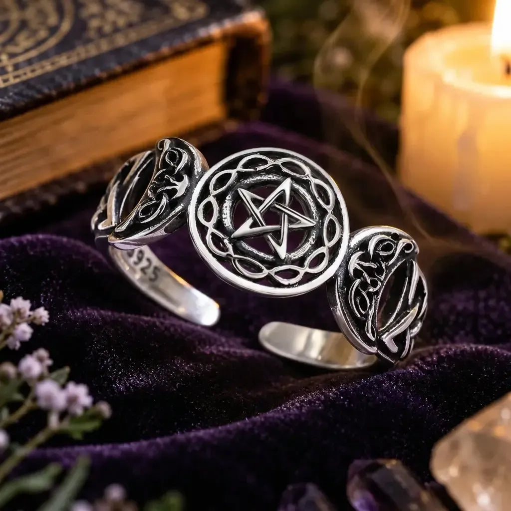 Open Triple Moon ring on a pale display surface