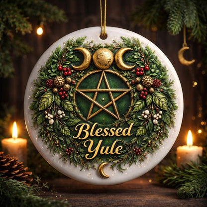 White ceramic Yule ornament with a gold Triple Moon, Pentacle, wreath, berries, and "Blessed Yule" text.