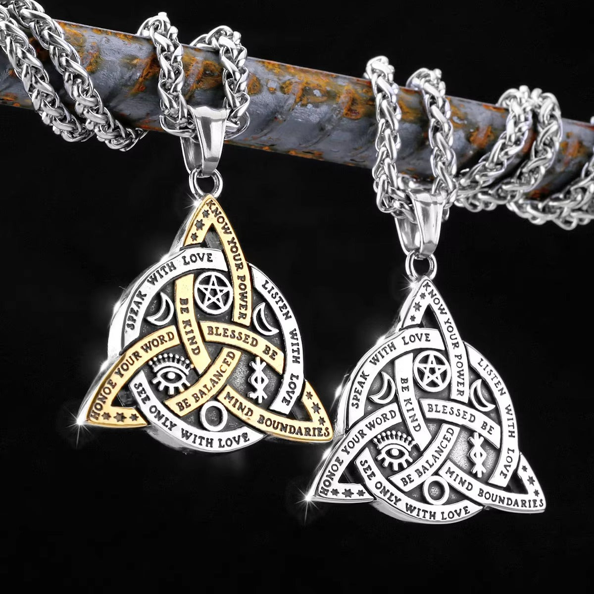 Two silver and gold Triquetra Celtic knot necklaces with engraved Wiccan symbols.