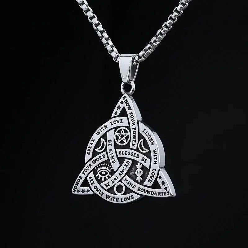 Silver Triquetra Celtics Knot Necklace with Wiccan symbols and empowering words on a black background.