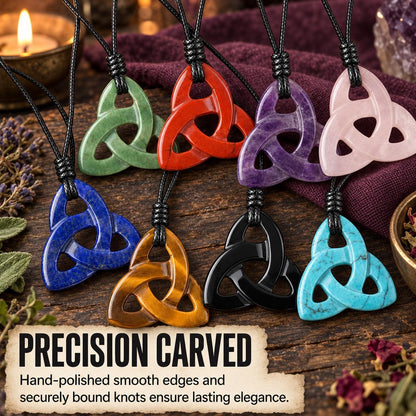 Carved triquetra stone necklaces on cords, arranged on a wooden surface in a witchy altar setting