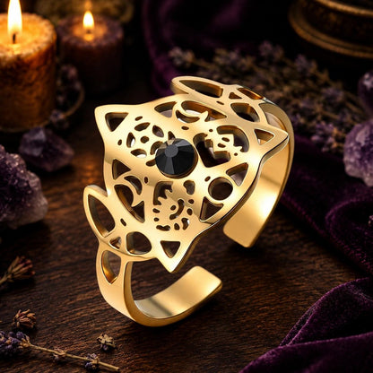 Gold Celtic Knot open ring close-up on a candlelit Pagan altar