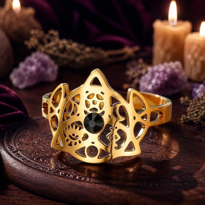 Gold Triquetra Trinity Knot adjustable ring on a candlelit Pagan altar