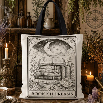 'Bookish Dreams' printed canvas tote bag: a tall stack of books beneath a crescent moon and stars, surrounded by roses.