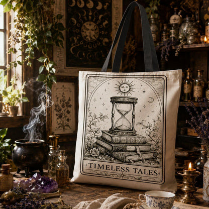 Canvas tote bag printed with 'Timeless Tales': an hourglass placed on a stack of books, topped with the sun, moon, and stars.